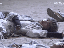 a person laying on the ground with the words & team written above them