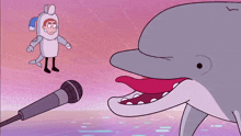 a man in a dolphin costume stands next to a microphone