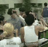 a group of people are sitting around a table and one of them is saying shuvee i love you donny .