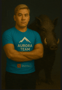 a man wearing a blue shirt that says aurora team stands next to a boar