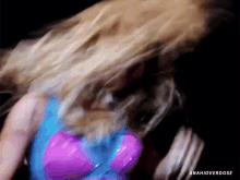 a woman in a blue and pink outfit is dancing and the words anahioverdose are visible in the corner