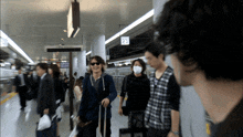 a group of people are walking in front of a sign that says 23 on it