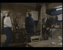 a man in a suit and tie is jumping in the air in a room with a watermark that says ujlaplaza