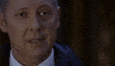 a close up of a man 's face with the words or i 'm g in red behind him