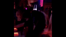 a woman in a top hat is standing next to a man in a hat .
