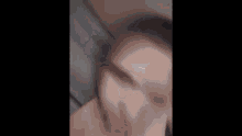 a close up of a person 's face with a blurred background