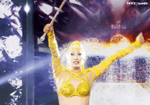 a woman in a yellow outfit is holding a wand in front of a t4yce tumblr logo