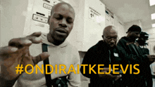 a group of men are standing in a laundromat with #ondiraitkejevis in yellow letters