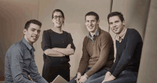 a group of people are posing for a picture together