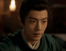 a close up of a man 's face with a surprised look on his face in a dark room .