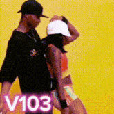 a man and a woman are dancing in front of a yellow background with the number 103 on the bottom .