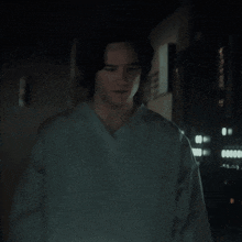 a man in a scrub is standing in a dark room