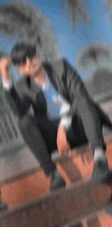 a blurry picture of a man sitting on a roof