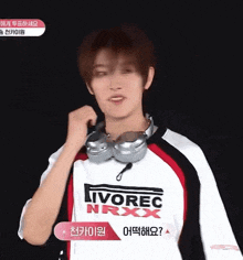 a young man wearing headphones and a ivorec nrxx shirt