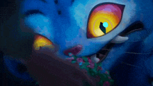 a close up of a blue cat 's face with bright yellow eyes