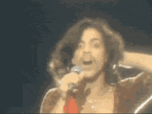 a man singing into a microphone with a beard
