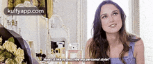 a woman is talking to another woman in a room and asking her how she likes to describe her personal style .