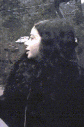 a close up of a woman 's face in a black coat