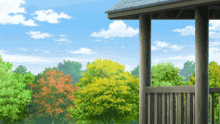 a balcony overlooking a park with trees and a blue sky