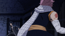 a man with a scarf around his neck is standing next to another man with bandaged arms