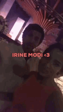 a man and a woman are posing for a picture with the text irine modi < 3 above them
