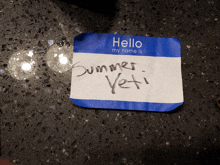a hello my name is summer yeti name tag on a counter
