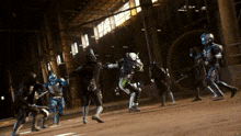 a group of superheros are fighting each other in a warehouse