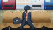 a boy is sitting on a couch with a briefcase that says ' a ' on it