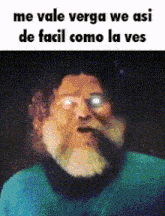 a man with a beard and glasses is making a funny face while wearing a blue shirt .