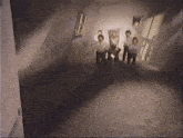 a group of people standing in a hallway with a window