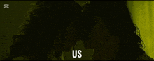 a couple kissing in a dark room with the word us below them