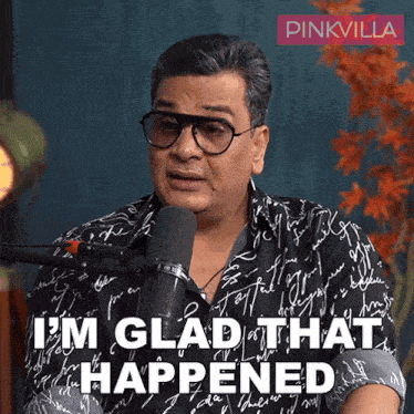 a man talking into a microphone with the words i 'm glad that happened on the bottom