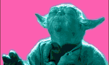 a close up of a statue of yoda with his eyes closed