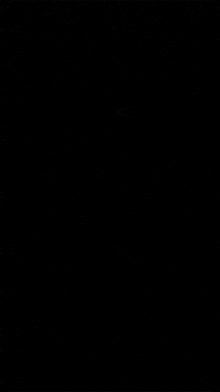 a green light is shining in the dark