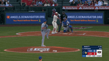 a baseball game is being played in front of a state farm banner