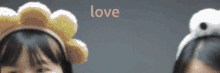 two girls with their arms in the air with the word love in the background