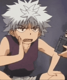 a cartoon character with white hair is sitting down and making a funny face .