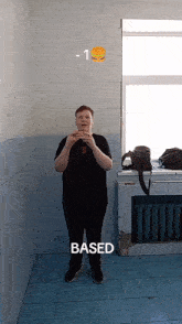 a boy is eating a hamburger in a room with the word based on the bottom