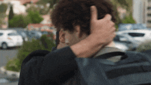 a person covering their face with their hand