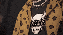 a person wearing a black shirt with a skull and horns on it
