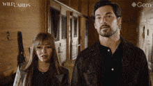 a man and a woman are standing next to each other in a hallway with the word wildcards on the bottom