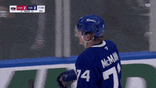 a hockey player wearing a blue jersey with the number 7 on it