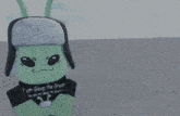 a green alien wearing a black shirt that says " i am gleep the great you are not gleep the great "