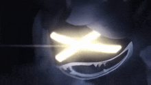 a close up of a person 's face with a light coming out of it in the dark .