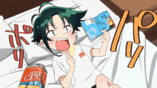 a girl laying on a bed reading a book next to a can of chips that says " パリ "