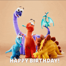 a group of stuffed dinosaurs standing next to each other with the words happy birthday written below them