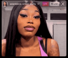 a woman with long hair is making a funny face while talking on a live stream .