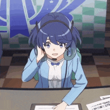 a girl wearing a headset is sitting at a table
