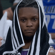 a man with a towel wrapped around his head with the number 27 behind him