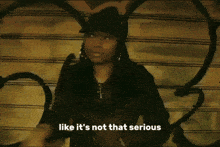 a woman says like it 's not that serious while wearing a hat